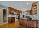 Well-equipped kitchen featuring dark wood cabinets, white appliances, and an island with a black countertop at 144 Cameron Dr, Salisbury, NC 28147