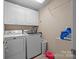 Well-equipped laundry room with modern washer and dryer and ample storage at 144 Cameron Dr, Salisbury, NC 28147