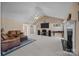 Open living room with vaulted ceilings, fireplace, carpet, and plenty of natural light at 144 Cameron Dr, Salisbury, NC 28147