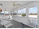 Bright and airy enclosed porch with white trim, ceiling fan, and multiple windows offering lovely views at 144 Cameron Dr, Salisbury, NC 28147