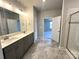 Spacious bathroom with double vanity, gray cabinets, marble floors, and a tiled shower at 160 Swann Rd # 6, Statesville, NC 28625
