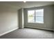 Bedroom with neutral walls, carpet, and large window offering plenty of natural light at 160 Swann Rd # 6, Statesville, NC 28625