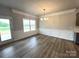 Bright dining room with elegant wainscoting, a modern chandelier and large windows at 160 Swann Rd # 6, Statesville, NC 28625