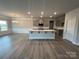 Kitchen island with white countertops and stainless sink, open to a living room with fireplace at 160 Swann Rd # 6, Statesville, NC 28625