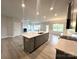 Modern kitchen featuring an island with seating, stainless steel appliances, and open to the living room at 160 Swann Rd # 6, Statesville, NC 28625