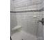 Modern shower with white subway tile, mosaic accent stripe, built-in shelf, and brushed nickel fixtures at 160 Swann Rd # 6, Statesville, NC 28625