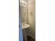 Small bathroom with pedestal sink, round mirror, and dark wood vanity at 1606 Lincoln Dr, Shelby, NC 28152