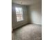 Well-lit bedroom with a window overlooking the backyard, carpeted floor at 1606 Lincoln Dr, Shelby, NC 28152