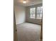 Bright bedroom with neutral walls and carpet, featuring two large windows at 1606 Lincoln Dr, Shelby, NC 28152