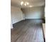Spacious living room with grey wood-look flooring and a chandelier at 1606 Lincoln Dr, Shelby, NC 28152