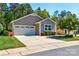 Charming single-story home featuring a well-manicured lawn and attached garage at 184 Flat Rock Dr, Denver, NC 28037