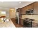 Gourmet kitchen featuring granite countertops, stainless steel appliances, and wood floors at 184 Flat Rock Dr, Denver, NC 28037