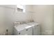 Bright laundry area featuring a washer and dryer with overhead shelving at 184 Flat Rock Dr, Denver, NC 28037