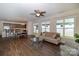 Bright living area featuring wood floors, a ceiling fan, and lots of natural light at 184 Flat Rock Dr, Denver, NC 28037