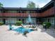 Relaxing courtyard with egg chairs, a patio umbrella, and serene accents at 2000 Patio Ct # 101, Charlotte, NC 28205