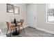 Cozy dining area featuring hardwood floors, table with seating for two, and a bright window at 2000 Patio Ct # 101, Charlotte, NC 28205