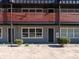 Apartment complex exterior with a gray facade, brown balcony, and landscaped yard at 2000 Patio Ct # 101, Charlotte, NC 28205