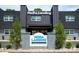 NoDa Landing Condominiums featuring a sign and well-maintained landscaping at 2000 Patio Ct # 101, Charlotte, NC 28205