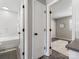 Hallway view to bathroom and bedroom featuring doors with modern matte black hardware at 2000 Patio Ct # 101, Charlotte, NC 28205