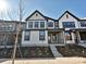 Modern 2-story townhome with white siding, black accents, and landscaped front yard at 207 Halemarge Drive Dr, Belmont, NC 28012