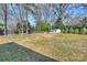 A spacious, green backyard with a storage shed, privacy fence and mature shade trees at 2100 Sunderland Pl, Charlotte, NC 28211
