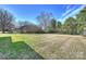The expansive backyard with mature trees and privacy fencing offers plenty of room for recreation and relaxation at 2100 Sunderland Pl, Charlotte, NC 28211