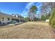 Expansive backyard featuring a patio with outdoor seating and mature trees at 2100 Sunderland Pl, Charlotte, NC 28211
