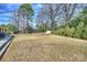 A well maintained flat backyard with mature trees and a storage shed at 2100 Sunderland Pl, Charlotte, NC 28211