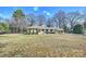 Well-kept one story house with a large front yard and a carport on a sunny day at 2100 Sunderland Pl, Charlotte, NC 28211