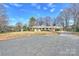 A nice one story house with a circular driveway and a covered carport at 2100 Sunderland Pl, Charlotte, NC 28211