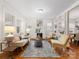 Bright and airy living room featuring a decorative fireplace, built-in shelving, and hardwood floors at 2132 Chesterfield Ave, Charlotte, NC 28205