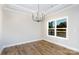 Bright dining area featuring wood flooring, a modern chandelier, and a large window with backyard views at 2364 Valley Meadows Dr, York, SC 29745