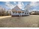 Lovely home boasts a spacious porch, neutral siding, and a well-maintained lawn at 2364 Valley Meadows Dr, York, SC 29745