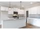 Modern kitchen featuring white cabinets, granite countertops, stainless steel appliances, and stylish pendant lighting at 2364 Valley Meadows Dr, York, SC 29745