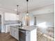 Modern kitchen features white cabinets, an island with a sink, and pendant lighting at 2364 Valley Meadows Dr, York, SC 29745
