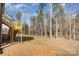 A large backyard of home, showing the deck, yard, and trees in the perimeter of the property at 2365 Kool Park Ne Rd, Hickory, NC 28601