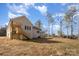 Exterior view of a white brick home, highlighting the outdoor space and landscaping potential in the backyard at 2365 Kool Park Ne Rd, Hickory, NC 28601