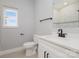 Well-lit bathroom featuring a modern vanity, toilet, and a shower with decorative tile at 2365 Kool Park Ne Rd, Hickory, NC 28601