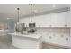 Modern kitchen with stainless steel appliances, a center island with seating, and white cabinets with sleek black hardware at 2365 Kool Park Ne Rd, Hickory, NC 28601