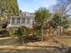Backyard with a deck and stairs, surrounded by mature trees, shrubs, and foliage at 2650 Whisper Ridge Ln, Matthews, NC 28105