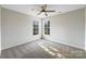 Well-lit bedroom featuring carpet and a ceiling fan at 2650 Whisper Ridge Ln, Matthews, NC 28105