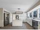 Modern kitchen with white cabinets, island, stainless steel appliances, and tile flooring at 2650 Whisper Ridge Ln, Matthews, NC 28105