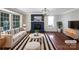 Virtually staged living room featuring a fireplace, hardwood floors, and ample natural light at 2650 Whisper Ridge Ln, Matthews, NC 28105