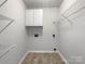 Laundry room with wire shelving and white cabinets at 3026 Windsor Chase Dr, Matthews, NC 28105