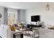 Open-concept living room with neutral tones, large window, stylish furnishings, and modern decor at 4114 Lattistep Ln, Charlotte, NC 28269