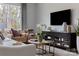 Inviting living room featuring comfortable seating, modern decor, a media center, and plenty of natural light at 4114 Lattistep Ln, Charlotte, NC 28269