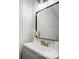 Bathroom featuring a sleek mirror, white vanity with storage, and modern fixtures at 4125 Rivendell Ln, Mint Hill, NC 28227