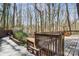 Spacious wooden deck with railings overlooks the wooded backyard, creating a serene outdoor living space at 4125 Rivendell Ln, Mint Hill, NC 28227