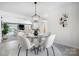 Cozy dining area with a round glass table and modern decor leading into the living room at 4125 Rivendell Ln, Mint Hill, NC 28227