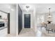 Modern entryway with stone accent wall, and gray door, illuminated by a pendant light at 4125 Rivendell Ln, Mint Hill, NC 28227